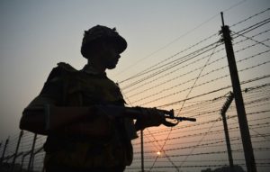 An Indian Border Security Force (BSF) soldier patrols along a fence at the India-Pakistan border in R.S Pora, southwest of Jammu, on October 3, 2016. / AFP PHOTO / TAUSEEF MUSTAFA
