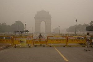 A Delhi policeman stands guard at the war memorial India Gate engulfed in a thick smog in New Delhi, India, Sunday, Nov. 6, 2016. The Delhi government has ordered that all city schools be shut, construction activity halted and all roads be doused with water as crippling air pollution has engulfed the Indian capital. The city, one of the world's dirtiest, has seen the levels of PM2.5 soar to over 900 microgram per cubic meter on Saturday, more than 90 times the level considered safe by the World Health Organization and 15 times the Indian government's norms. (AP Photo/Manish Swarup)