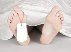 Dead body with toe tag, under a white sheet