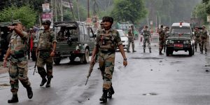 Jammu: Army personnel guard at a street during  curfew in Jammu on Monday. The curfew has been clamped by the authorities in the view of violent protests over Kishtwar clash. PTI Photo (PTI8_12_2013_000096B)