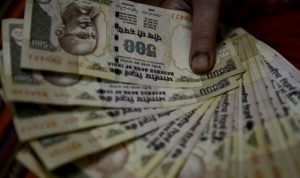 An Indian woman holds 500 INR currency notes at her home in Faridabad, a suburb of New Delhi, on November 8, 2016.  Indian Prime Minister Narendra Modi announced late November 8 that 500 and 1,000 ($15) rupee notes will be withdrawn from financial circulation from midnight, in a bid to tackle corruption. "To break the grip of corruption and black money, we have decided that the 500 and 1,000 rupee currency notes presently in use will no longer be legal tender from midnight ie 8 November, 2016," Modi said in a special televised address to the nation. / AFP / MONEY SHARMA        (Photo credit should read MONEY SHARMA/AFP/Getty Images)